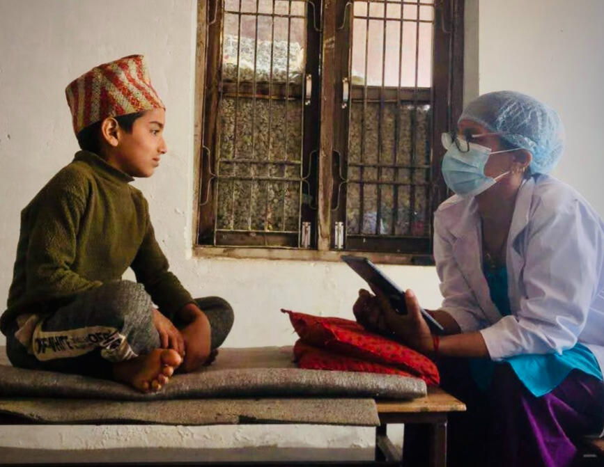 Dental Technician Sarala meets with a young patient at a school seminar.